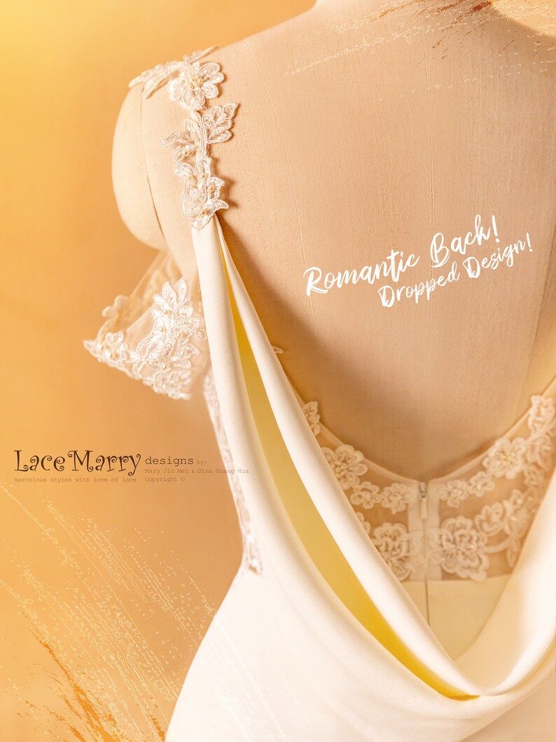 May include: A white wedding dress with a lace bodice and a draped back. The back of the dress has a romantic dropped design. The text "Romantic Back! Dropped Design!" is written on the dress.