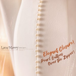 May include: A white dress with a zipper closure and a row of pearl buttons down the back. The text "Elegant Closure! Pearl Buttons Over the Zipper!" is written in orange on the dress.