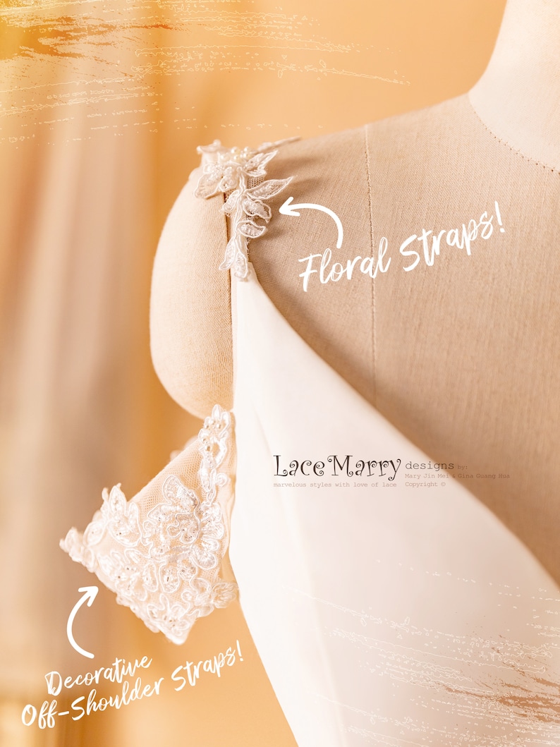May include: A white off-the-shoulder dress with delicate lace straps. The straps are decorated with floral appliques. The dress is on a white mannequin. The text "Lace Marry designs" is visible on the dress.