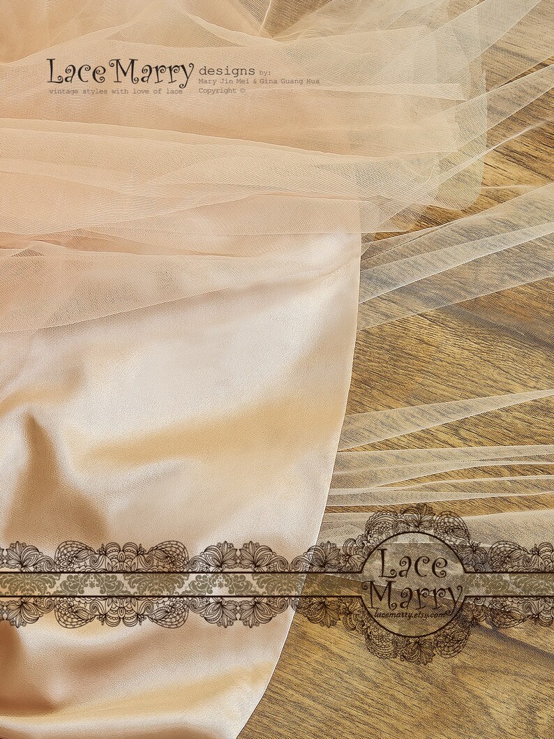 May include: A close-up of a piece of beige tulle fabric with a delicate lace trim. The fabric is draped over a wooden surface. The text "Lace Marry designs by Mary Jin Mei & Gina Guang Hua vintage styles with love of lace Copyright o" is visible in the top left corner of the image. The text "Lace Marry lacematty.etsy.com" is visible in the bottom right corner of the image.