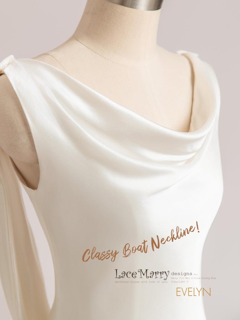 Pu&ograve; includere: Primo piano di un abito bianco in satin con scollo a barca. Lo scollo &egrave; drappeggiato e ha un effetto a scialle. Il testo "Classy Boat Neckline! Lace Marry designs by Mary Ji Mei & Gina Guang Niu.  Beautiful styles with love of lace. Copyright &copy; EVELYN" &egrave; visibile sull'abito.