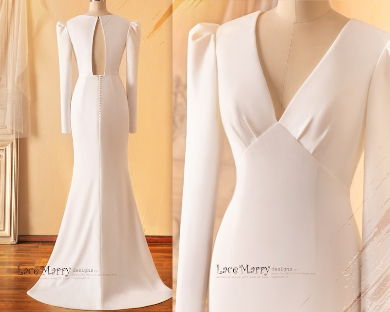 May include: A white long-sleeved wedding dress with a fitted bodice, a V-neckline, and a low back. The dress has a fitted silhouette and a flowing skirt. The dress is shown from the front and back.