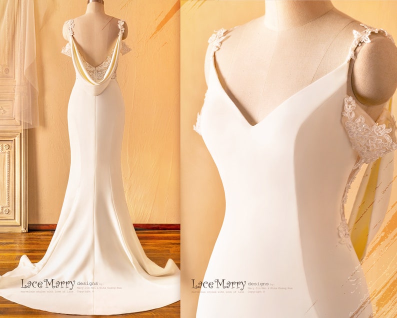 May include: A white wedding dress with a fitted bodice, a V-neckline, and a flowing skirt. The dress features delicate lace straps and a low back with a draped detail. The dress is shown on a mannequin.
