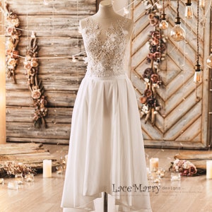 Two Piece Wedding Dress Set from Lightly Beaded Transparent Crop Top with 3D Flower Applique and Ample High Low Skirt in Folded Modern Cut Lace Top + Skirt