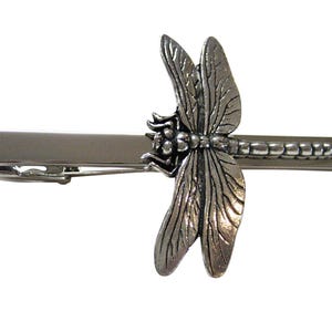 May include: Silver tie clip featuring a detailed dragonfly design.