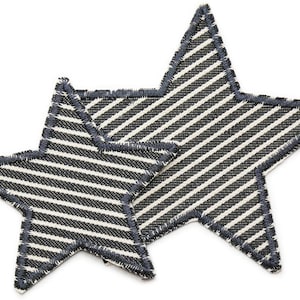 May include: Two black and white striped fabric stars with a blue stitched edge.