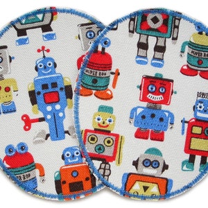 May include: Two round fabric patches with a white background and a blue border. The patches are covered in a repeating pattern of colorful robots with different designs.