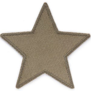 May include: A large, five-pointed star-shaped patch in a muted olive green color. The star is made of a textured fabric with a stitched outline.