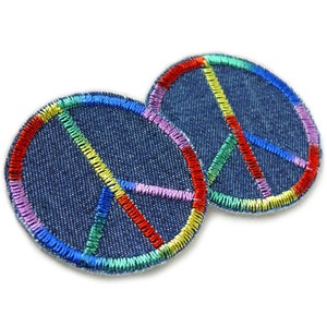 May include: Two denim peace sign patches with rainbow colored embroidery.