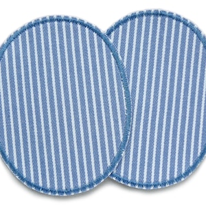 May include: Two round, blue and white striped fabric pads with a blue stitched edge.