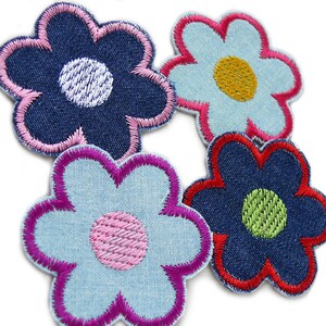 May include: Four denim flower patches with different colored embroidery. The flowers are blue, light blue, and dark blue with pink, red, yellow, and green embroidery.