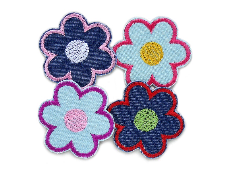 May include: Four denim flower patches with different colored centers. The flowers are blue, light blue, and dark blue with pink, yellow, and green centers.