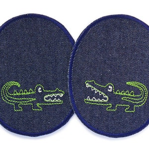 May include: Two blue denim oval patches with green embroidered alligator designs. One alligator is facing left and the other is facing right.