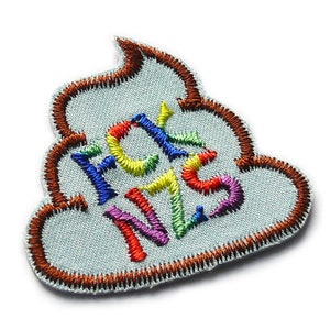 May include: A brown embroidered patch shaped like a pile of poop with the word "FCK NZS" written in rainbow colors.