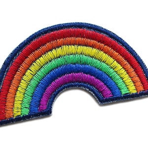 Può includere: Una toppa ricamata a forma di arcobaleno. La toppa è bordata di denim blu scuro.