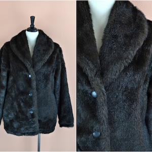 May include: A dark brown faux fur jacket with a large collar and three buttons down the front.