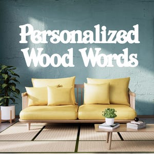 May include: A living room scene featuring a yellow sofa with matching pillows, a wooden coffee table, and a potted plant. The words "Personalized Wood Words" are displayed in white on the teal wall above the sofa.