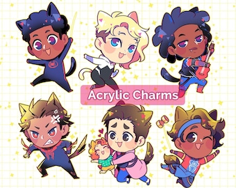 May include: Six colorful acrylic charms featuring cartoon characters with animal ears. The characters are wearing different outfits and accessories, including a guitar, a spider web, and a cat costume. The text "Acrylic Charms" is displayed in a pink banner.