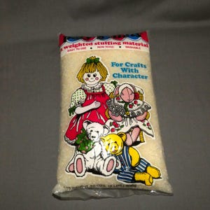 May include: A white ceramic mug with a black handle and the text "But First, Coffee" in a black, bold font. The mug is sitting on a wooden surface.