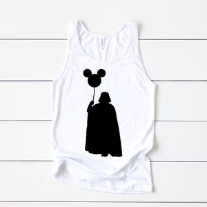 May include: White tank top with a black silhouette of Darth Vader holding a Mickey Mouse balloon.