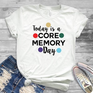 May include: White t-shirt with the text "Today is a CORE MEMORY Day" in black with colorful dots.