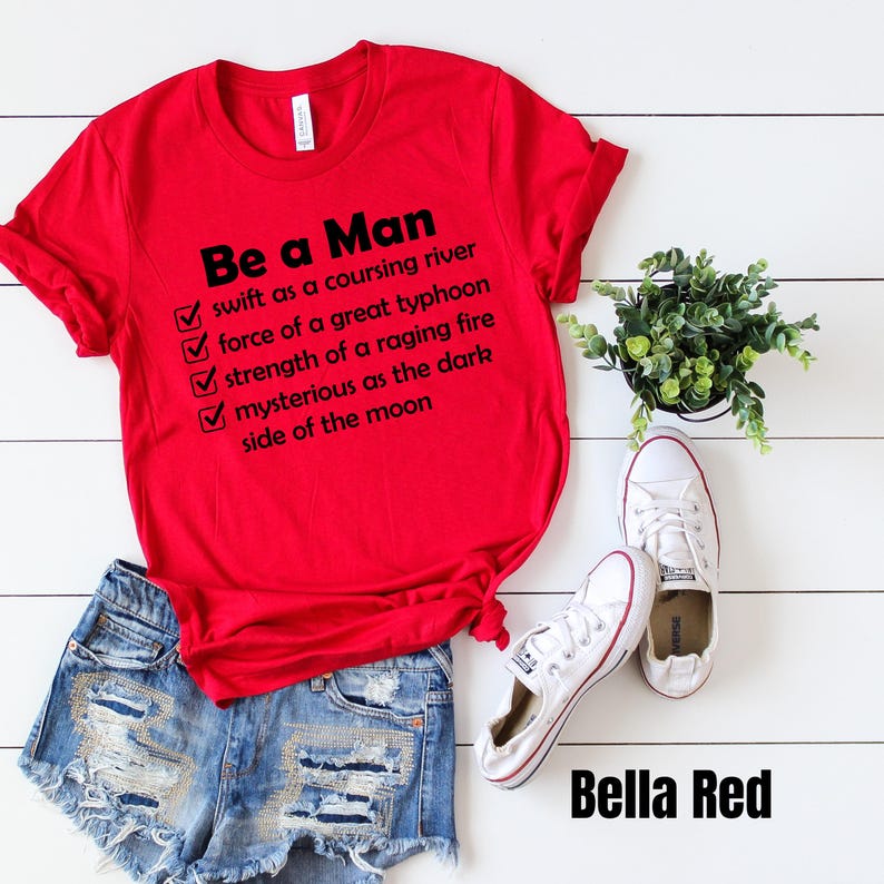May include: Red t-shirt with a white checklist and the text "Be a Man" followed by a list of qualities: "swift as a coursing river", "force of a great typhoon", "strength of a raging fire", "mysterious as the dark side of the moon".