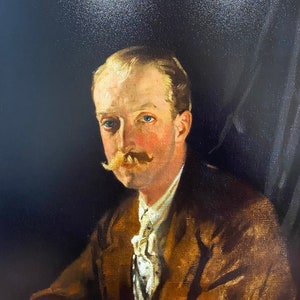 May include: A painting of a man with a mustache wearing a brown jacket and a white shirt with a bow tie. The background is dark.