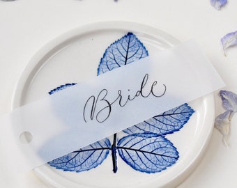 Elegant wedding place names - quality vellum paper with black handwritten calligraphy, punched hole