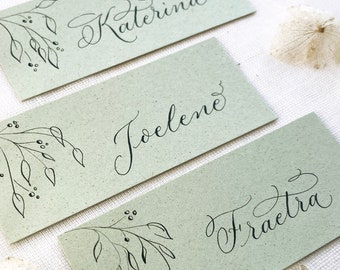 Natural green wedding place names with hand calligraphy, made in the UK from sustainable recycled card