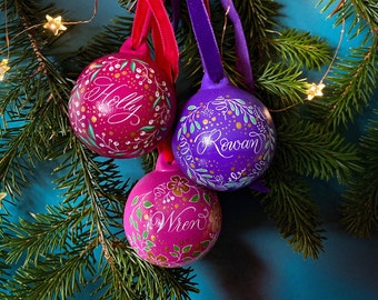 Hand painted personalised name baubles in pink, magenta or purple
