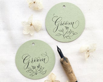 Round green wedding place names with hand calligraphy, made in the UK from sustainable recycled card