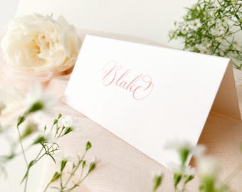 White tent fold wedding place name cards with calligraphy