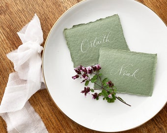 Sage green handmade paper calligraphy wedding place names