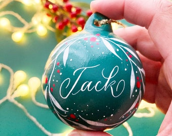 Hand painted personalised name baubles with calligraphy and leaf illustrations