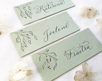 Natural green wedding place names with hand calligraphy, made in the UK from sustainable recycled card