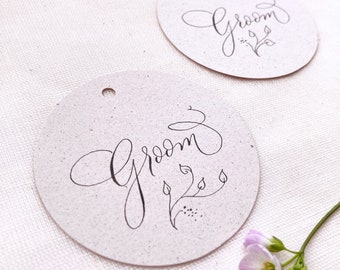 Circular wedding place names with hand calligraphy, made in the UK from sustainable recycled card