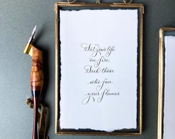 Motivational calligraphy quote in a rustic brass frame