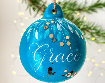 Vibrant blue personalised name bauble with handwritten calligraphy