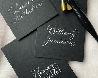 Luxury black wedding place cards with calligraphy written by hand