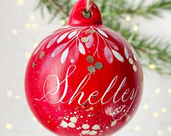 Red personalised name bauble with handwritten calligraphy