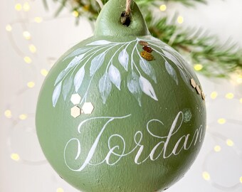 Sage green personalised name bauble with handwritten calligraphy