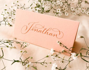 Peach folded wedding place names with calligraphy