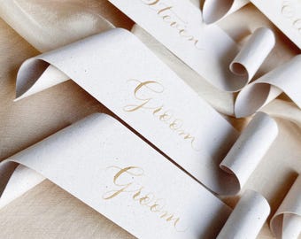Scroll wedding place cards on recycled paper