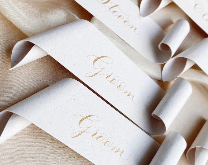 Featured listing image: Scroll wedding place cards on recycled paper