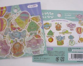 May include: Two packages of Baby Elephant Circus flake stickers featuring watercolor-style illustrations of elephants in various circus poses, including balloons, balls, and boxes. The packaging includes the text Joyful Daily Life of Animals.