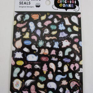 May include: A sheet of colorful stickers featuring various cartoon ghost designs. The stickers are on a black background and include Japanese text. The text reads "GITCHIRI OBAKE" and "DARE 77".