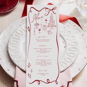 May include: A festive table setting with a red and gold color scheme. Includes a menu, plates, silverware, a champagne glass, and a coffee cup. The menu features a Christmas tree illustration and a list of appetizers and desserts.