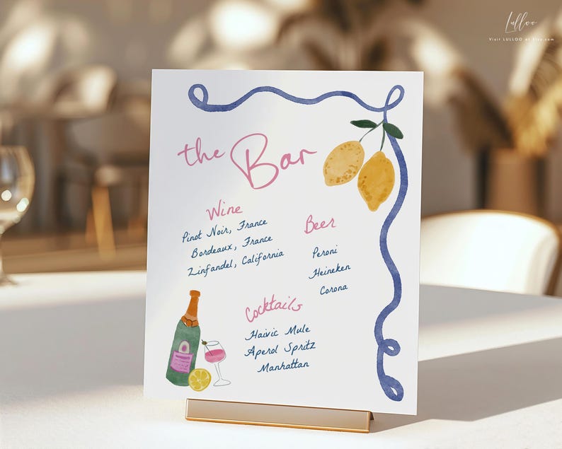 May include: A white sign with blue and pink lettering that reads "the Bar". The sign lists wine, beer, and cocktail options. The sign is decorated with lemons and a blue swirl.