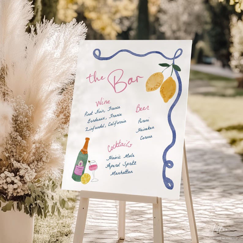 May include: A white sign with blue and pink lettering that reads "the Bar". The sign lists wine, beer, and cocktail options. The sign is decorated with lemons and a bottle of wine.