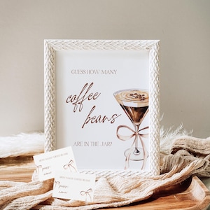 May include: A framed sign with the text "GUESS HOW MANY coffee beans ARE IN THE JAR?" features a watercolor illustration of a coffee drink. Two small cards with the text "HOW MANY COFFEE BEANS" are also visible.